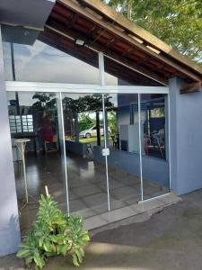 a screened in porch of a house with glass at Estância arco iris in Regente Feijó