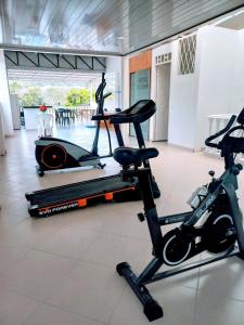 a gym with two exercise bikes and a treadmill at Hotel Colombia - Apulo in Apulo