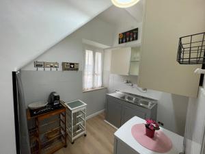 a small kitchen with a sink and a counter at Arkem's home in Norma