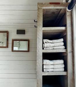 a wooden shelf with towels in a room at BelleLiv in Nijlen +11 photos