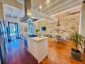 a kitchen with a counter and a stone wall at Casa Klod Ibiza in Ibiza Town