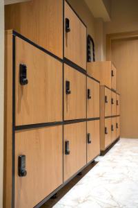 a row of wooden lockers in a room at Chania Capsule Stay in Chania