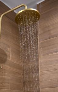 a shower in a bathroom with a shower head at Chania Capsule Stay in Chania