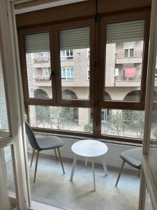 a room with a window with two chairs and a table at Hostal San Fernando in Santander