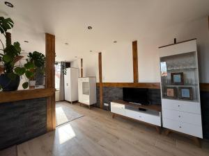 a large living room with a television and a counter at Studio Lec in Giżycko