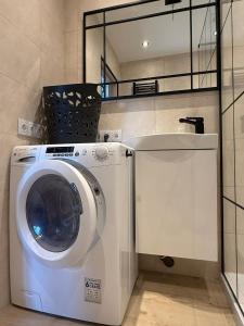 a washer and dryer in a room with at Studio Lec in Giżycko +15 photos