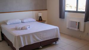 a bedroom with a bed with two towels on it at Maktub Hotel Itu in Itu +32 photos