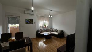 a living room with a couch and a table at Rest apartment Niksic in Nikšić