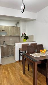 a kitchen and dining room with a table and chairs at Rest apartment Niksic in Nikšić +9 photos