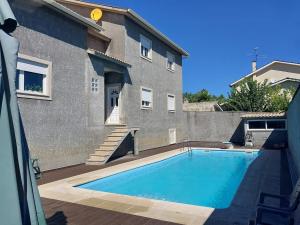a swimming pool in front of a building at Casa Flamingo in Viseu
