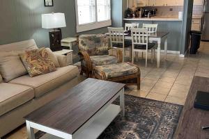 a living room with a couch and chairs and a table at Salty Paws II in Kill Devil Hills