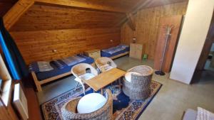 an overhead view of a room with beds and a table and chairs at Chalupa Kruh in Doksy
