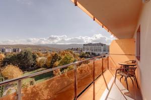 a balcony with a table and a view of the city at ZEN Rezidential Apartments in Cluj-Napoca