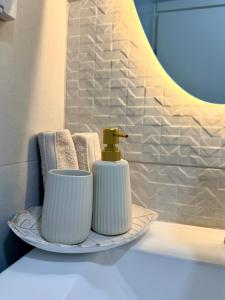 a bathroom sink with a soap dispenser and a mirror at Pure Sense in Beʼer Ora +45 photos