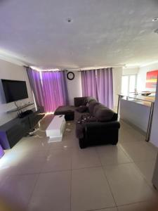 a large living room with a couch and a tv at Ocean Haven in Walvis Bay