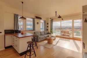 a kitchen and living room with a couch and a table at ZEN Rezidential Apartments in Cluj-Napoca