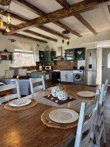 a kitchen and dining room with a table and chairs at Casa di Mare Stegna in Archangelos