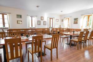 a dining room with wooden tables and chairs at Mayer Pince Panzió in Villány +15 photos