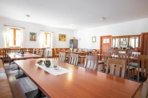 a dining room with wooden tables and chairs at Mayer Pince Panzió in Villány