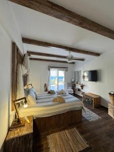 a bedroom with a large bed and a window at Casa di Mare Stegna in Archangelos +75 photos