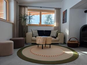 a living room with a table and a couch at Hanselerhof Jaufental Ratschings mit Sauna in Racines