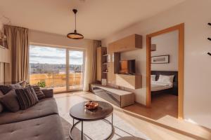 a living room with a couch and a table at ZEN Rezidential Apartments in Cluj-Napoca