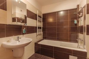 a bathroom with a sink and a bath tub at ZEN Rezidential Apartments in Cluj-Napoca +109 photos