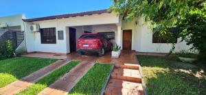 a red car parked in front of a house at Casa a metros de todo in Federación