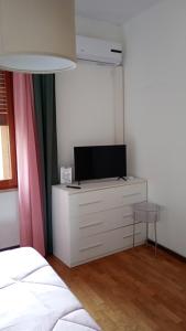 a bedroom with a dresser with a tv on it at Home in Arezzo +54 photos