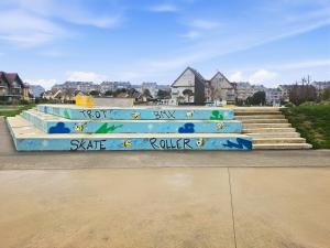 a bench with graffiti on it next to some stairs at Sérénité vue mer in Courseulles-sur-Mer