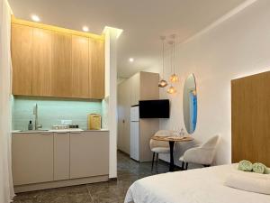 a kitchen and a room with a bed and a table at Pure Sense in Beʼer Ora