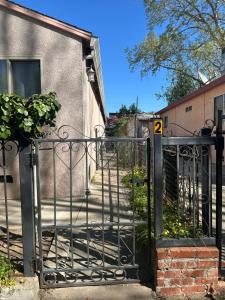 an iron gate with a stairway in front of a building at Downtown Private Master Suite in Sacramento
