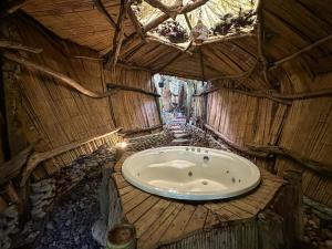 a bathroom with a tub in a bamboo house at Amara Hotel in Doradal +51 photos
