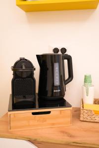 a coffee maker sitting on top of a wooden stand at Riganvì Affittacamere Sestu in Sestu