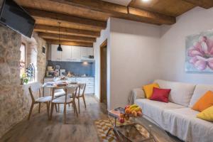 a living room with a couch and a table at Holiday home Dida Jere in Benkovac +2 photos