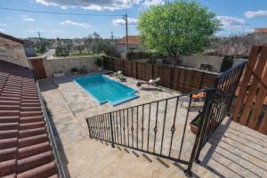 a swimming pool in a yard next to a staircase at Holiday home Dida Jere in Benkovac
