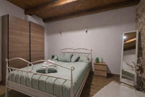 a bedroom with a metal bed and a mirror at Holiday home Dida Jere in Benkovac