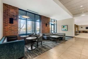 a lobby with couches and tables and windows at Hyatt Place Florence Downtown in Florence