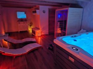 a large bathroom with a tub with purple lighting at Hiša Skala Kubed in Gračišče +30 photos