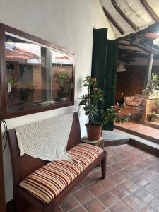 a bench sitting on a patio with a window at Casa casco urbano in San Gil +15 photos