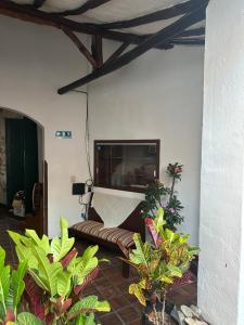 a living room with a couch and a flat screen tv at Casa casco urbano in San Gil