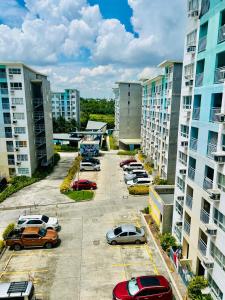 a parking lot with cars parked in front of tall buildings at Dysha's Home in Davao City