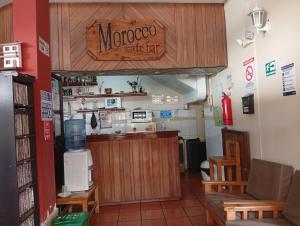 a coffee shop with a mongoose cafe sign on the wall at Hospedaje Las Garzas in Ibarra