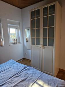 a bedroom with a large white closet and a bed at Mary´s Ferienwohnung in Kevelaer