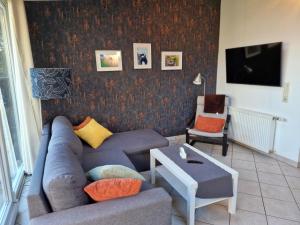 a living room with a couch and a table at Mary´s Ferienwohnung in Kevelaer