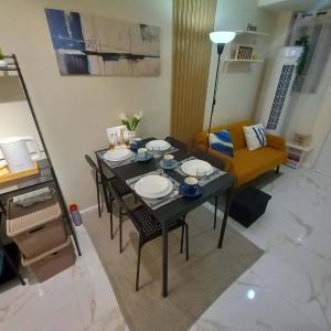 a living room with a table and a couch at Tanza, Cavite Transcient House near SM in Tanza +18 photos