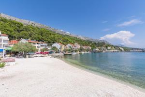 a beach in a town next to the water at Apartments Blue Adriatic View in Jesenice