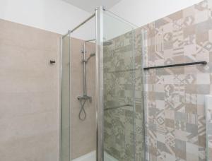 a shower with a glass door in a bathroom at Apartments Blue Adriatic View in Jesenice +52 photos