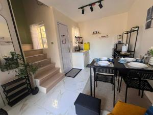 a room with a table and chairs and a kitchen at Tanza, Cavite Transcient House near SM in Tanza