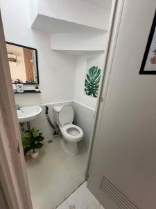 a small bathroom with a toilet and a sink at Tanza, Cavite Transcient House near SM in Tanza